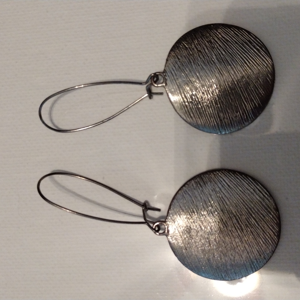 Large medallion earrings.